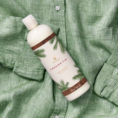 Thymes Frasier Fir Fabric Softener laundry care flat lay on green shirt